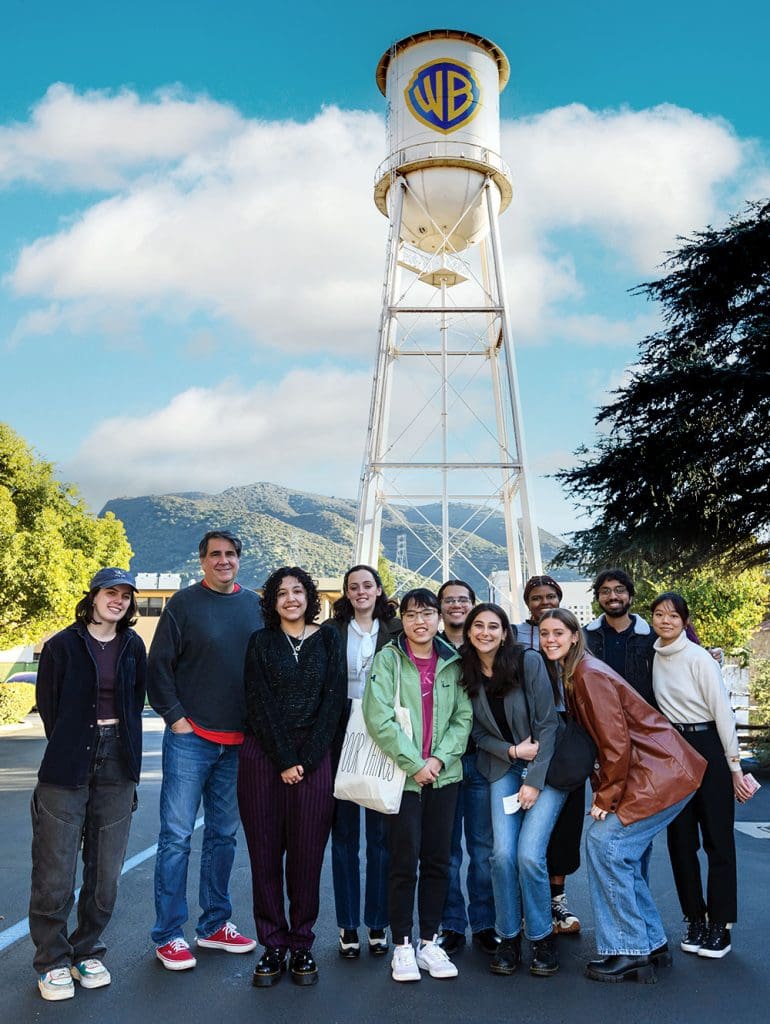 Group shot of students and alum Mark Swift ’93 in front of water tower at Warner Brothers studion in Los Angeles, California.
