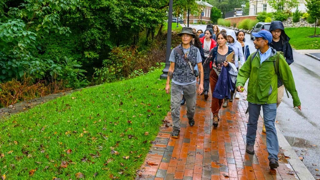 Pandian's class walking on a rainy day on Homewood campus to Stoney Run