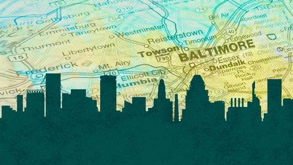 silhouette of buildings on Baltimore skyline, map showing Baltimore in the background