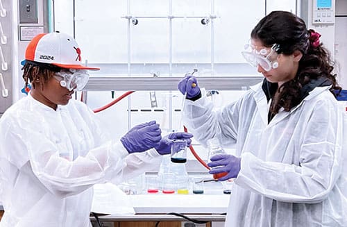 high school students at work in chemistry lab