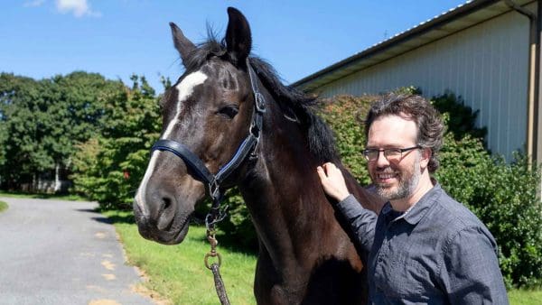 Brian Camley holding the reins to a horse