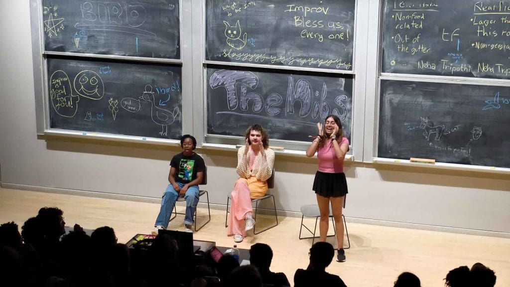 three members of the comedy improv group Buttered Niblets perform