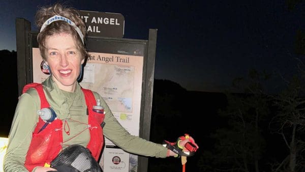 Emily Riehl in front of a trail sign