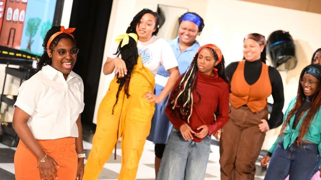 A group of Black female student actors standing together smiling