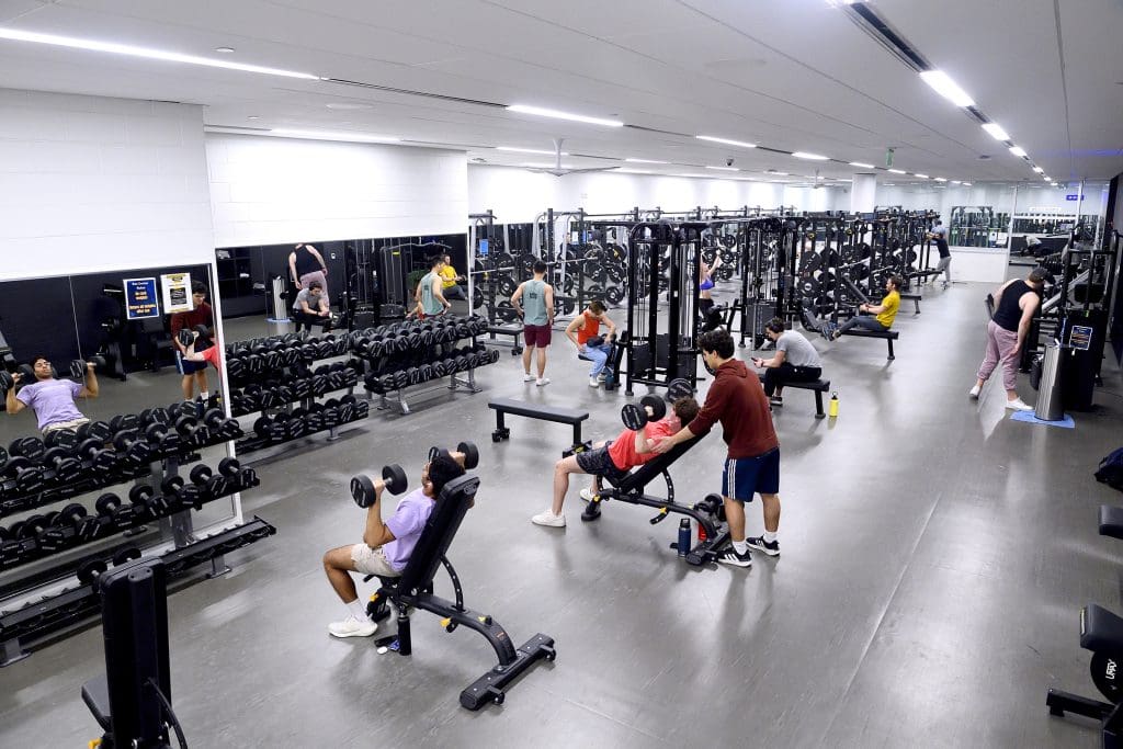 Multiple people using gym equipment in the Rec Center