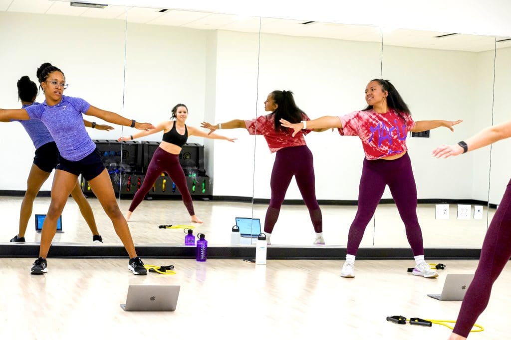 Multiple people exercising in the Rec Center dance room