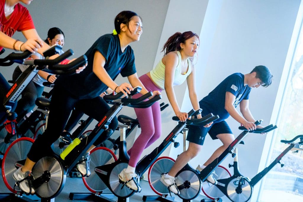Multiple people on exercise bikes.