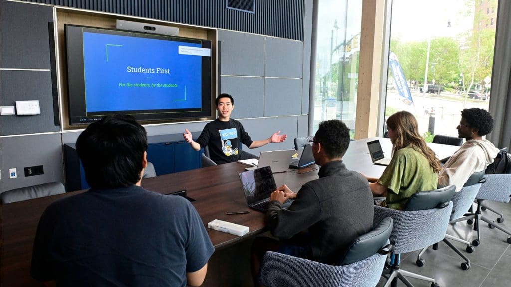 Students gathered at a conference table in The Bloomberg Student Center.