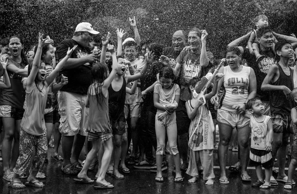 Families attend the Wattah Wattah Festival on the Feast Day of San Juan in Manila, Philippines, 2019.