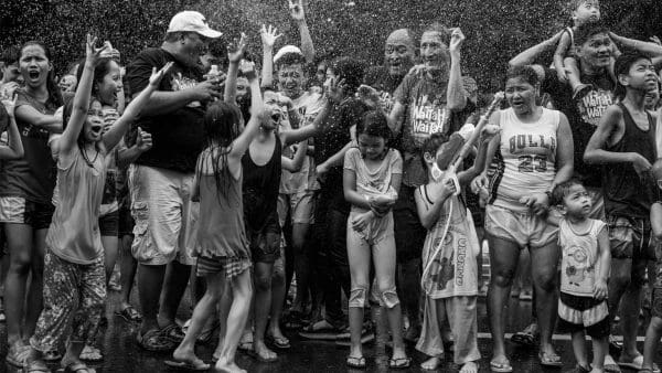 Families attend the Wattah Wattah Festival on the Feast Day of San Juan in Manila, Philippines, 2019.