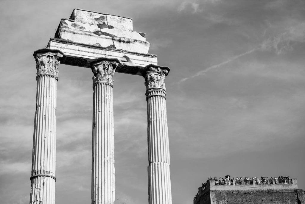 Tourists behold the three remaining pillars of the Temple of Castor and Pollux, Rome, Italy, 2025.