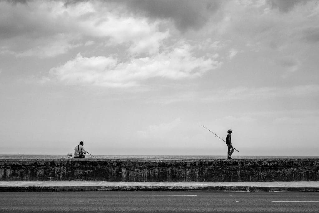 Fishers try their luck along the Malecón in Havana, Cuba, 2019.
