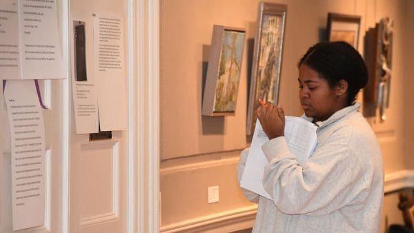 Andra Morrison writes feedback for another student’s exhibit text in “Lost Baltimore.”