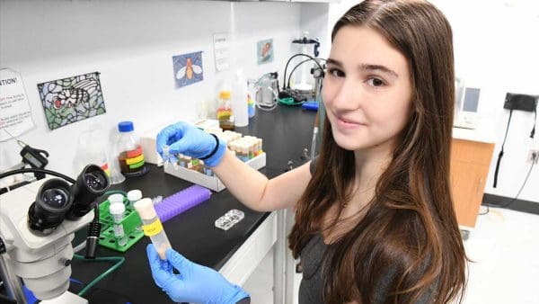 Bella Rowe in lab with fly samples.