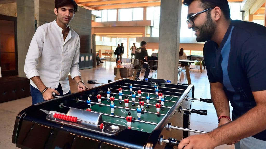 Two students playing foosball