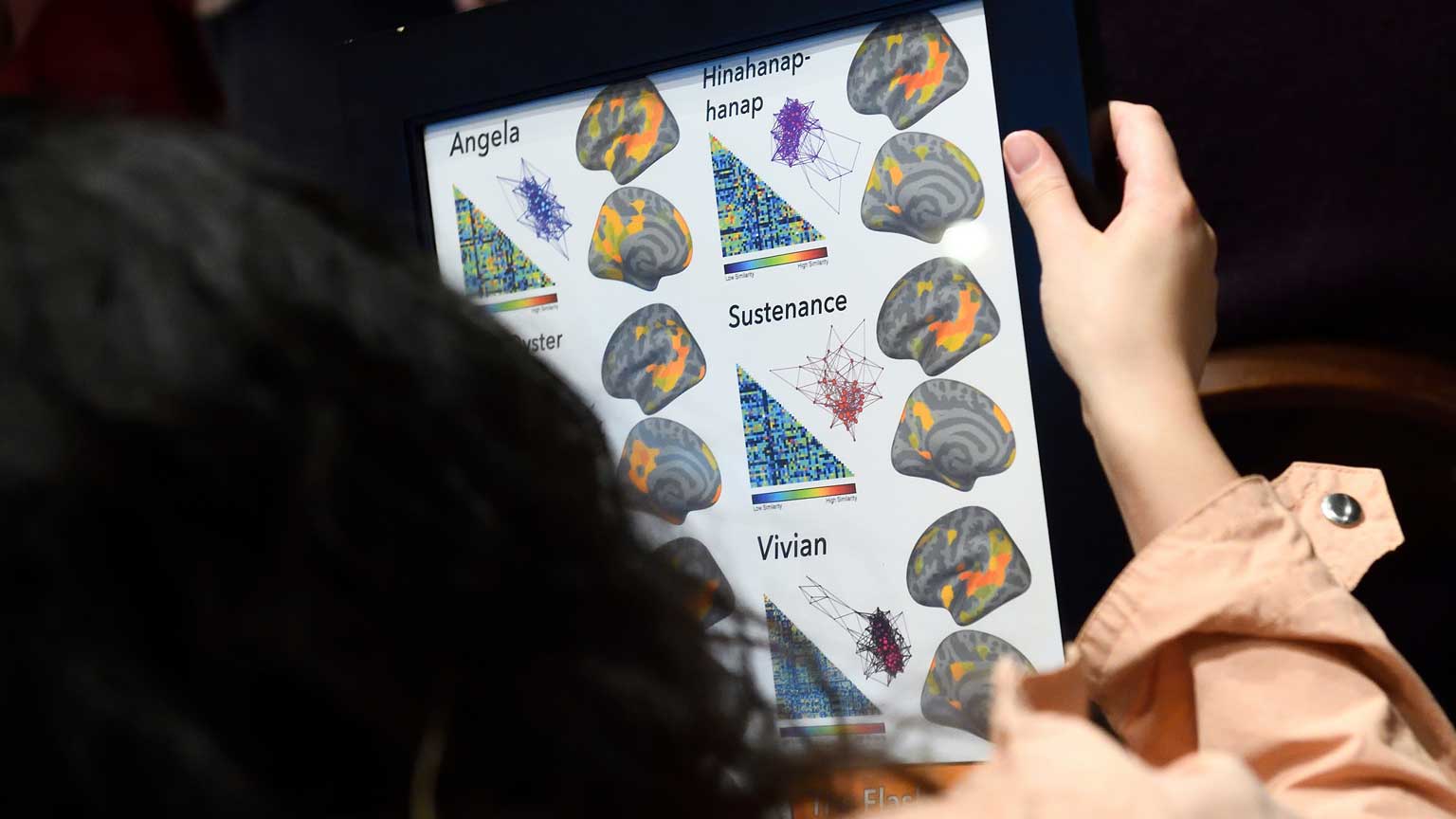 Samira Tavassoli holding the fMRI framed poster