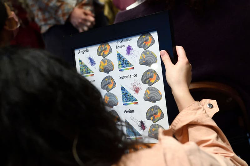 Samira Tavassoli holding the fMRI framed poster  