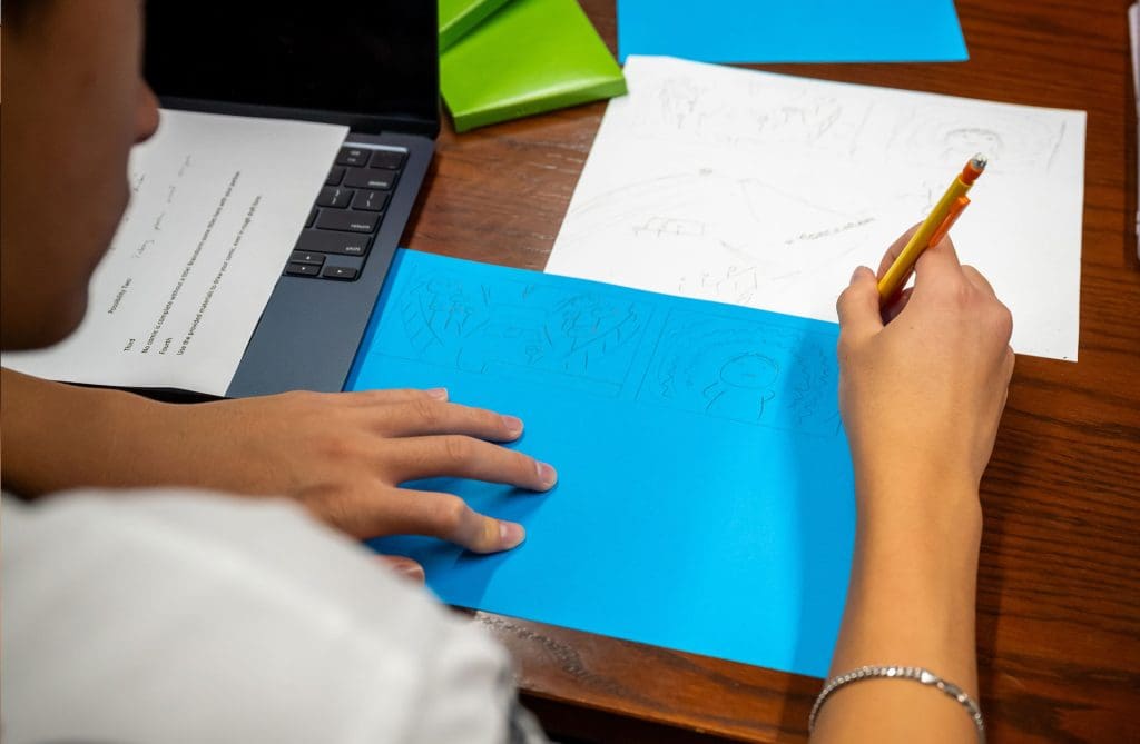 A student makes a rough
comic draft in “Comics, History, Lives.”