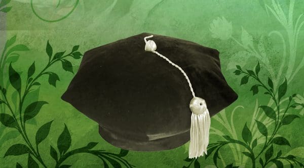 A PHD graduation cap on an illustrated green background with leaves.