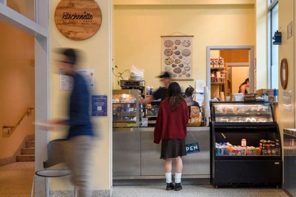 Student standing in front of counter at a campus cafe.